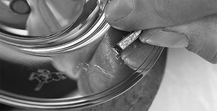 Pewter being engraved by hand